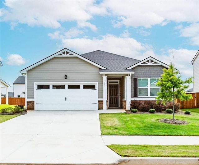 977 Daurian Dr, Statham, GA 30666 - craftsman-style house with driveway, a garage, and brick siding