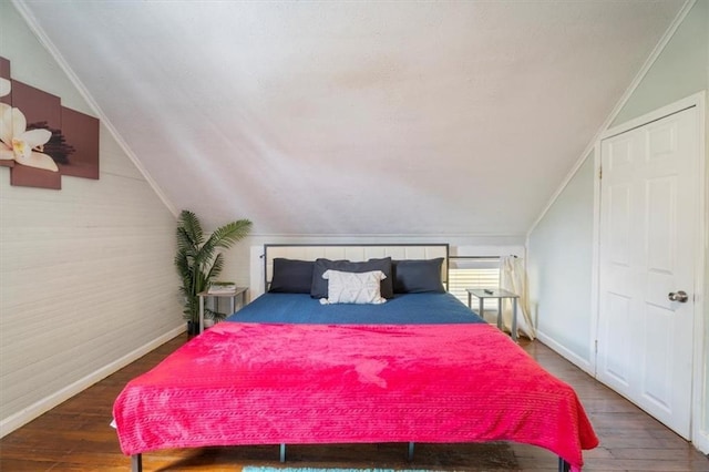 bedroom featuring lofted ceiling and hardwood / wood-style flooring