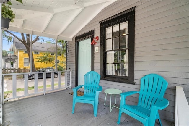 sunroom with wood ceiling and vaulted ceiling with beams