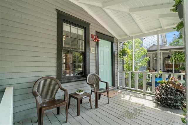 sunroom featuring wood ceiling and vaulted ceiling with beams