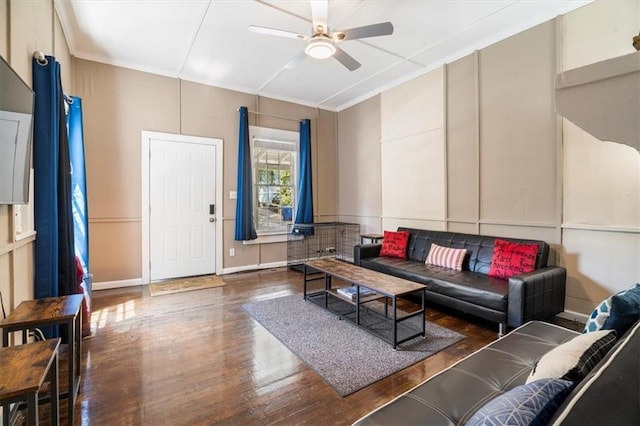 living room featuring ceiling fan and dark hardwood / wood-style floors