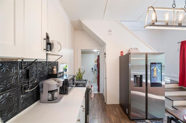 kitchen featuring appliances with stainless steel finishes, tasteful backsplash, dark hardwood / wood-style flooring, pendant lighting, and white cabinets