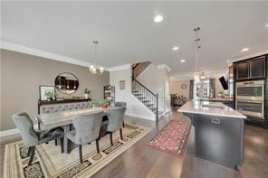 dining room featuring ornamental molding, dark hardwood / wood-style flooring, and a chandelier