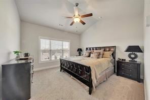 carpeted bedroom with ceiling fan and vaulted ceiling