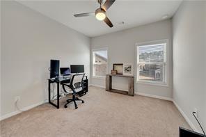 home office featuring ceiling fan and light colored carpet