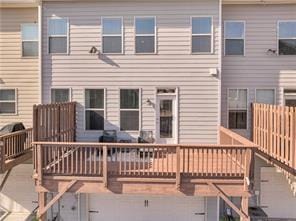 rear view of house with a wooden deck