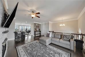 living room featuring ornamental molding, wood-type flooring, and ceiling fan with notable chandelier