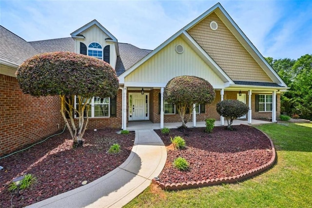 330 Pitts Chapel Rd, Newborn, GA 30056 - view of front of home featuring brick siding, a porch, board and batten siding, and a front yard