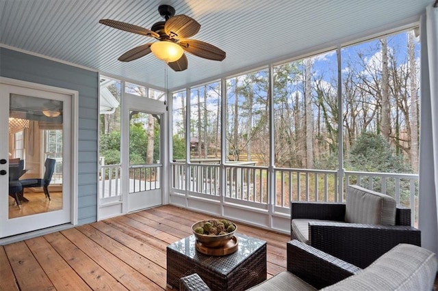 sunroom with a wealth of natural light and ceiling fan