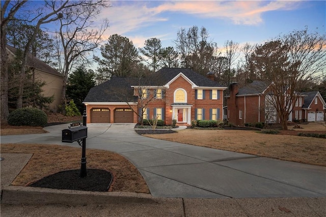 view of front of home featuring a garage and a yard