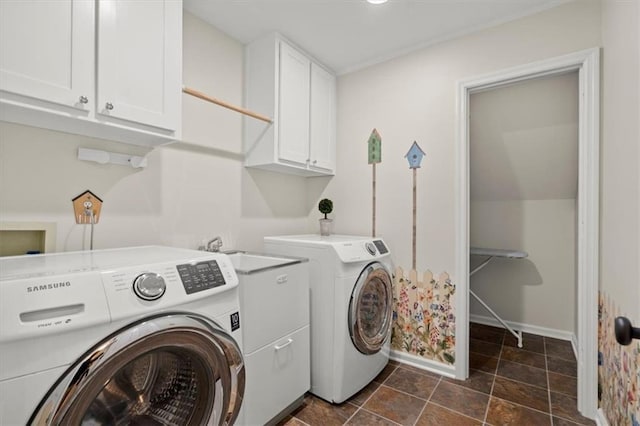 laundry room featuring cabinets and separate washer and dryer