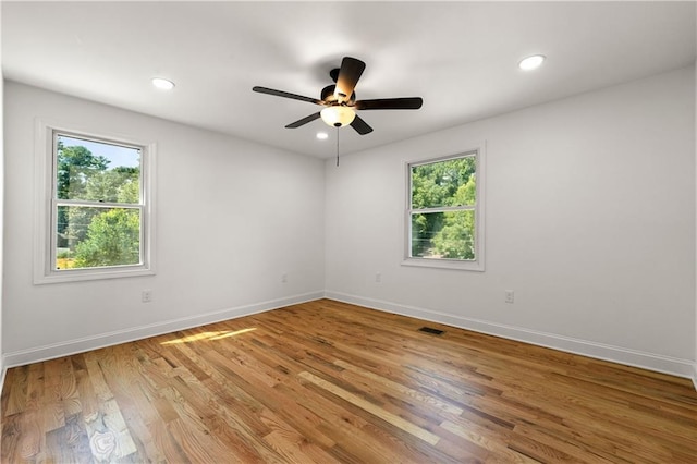 unfurnished room with recessed lighting, a ceiling fan, light wood-type flooring, and baseboards