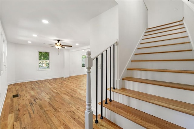 stairway featuring a ceiling fan, recessed lighting, wood finished floors, and baseboards