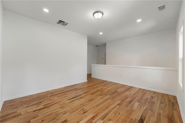 empty room featuring recessed lighting, visible vents, and light wood-style floors