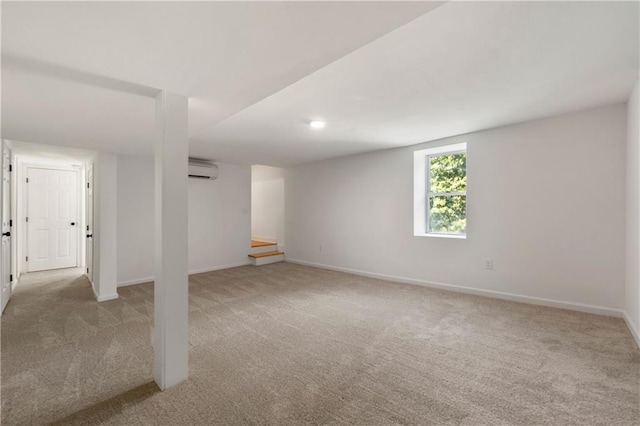 basement with an AC wall unit, baseboards, and carpet