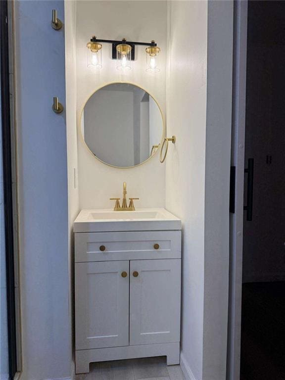 bathroom with vanity and baseboards