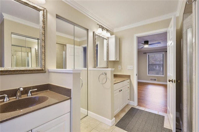 bathroom featuring tile patterned floors, ceiling fan, ornamental molding, and vanity