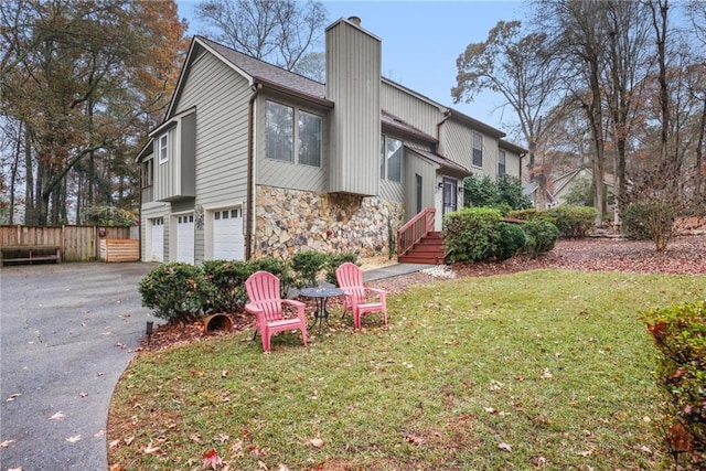 view of side of property with a yard and a garage