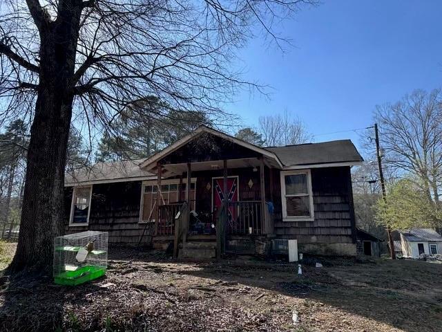 view of front of house with covered porch and central AC