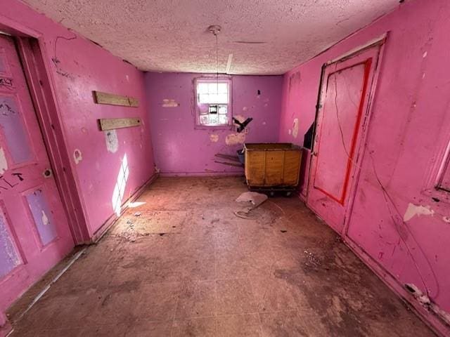 miscellaneous room featuring a textured ceiling