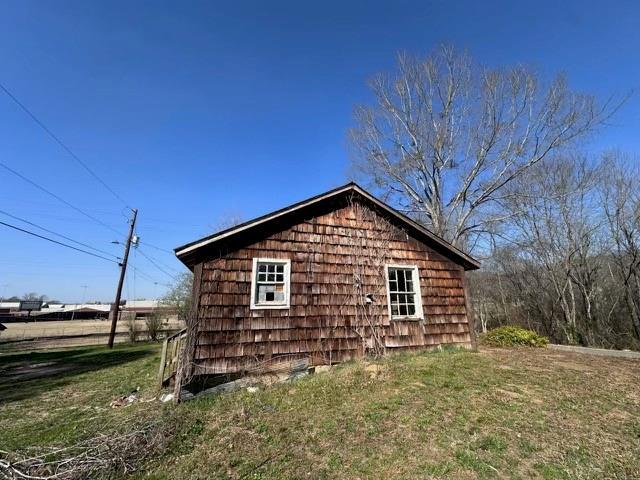 view of side of home featuring a yard