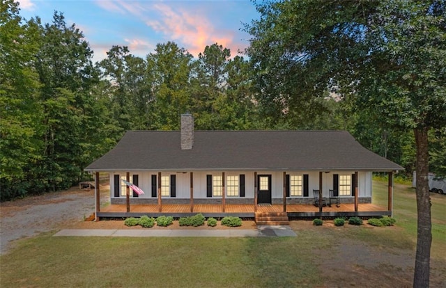 view of front of house with a porch and a lawn