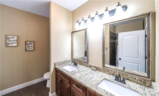 bathroom with vanity, tile patterned floors, toilet, and walk in shower