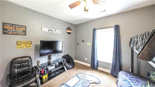 living room with ceiling fan, carpet flooring, and a wealth of natural light