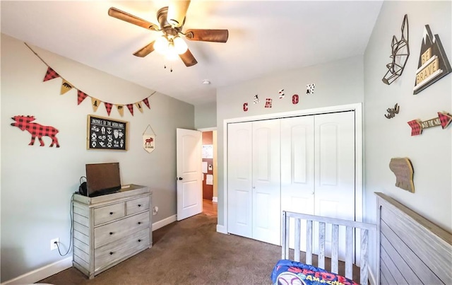 carpeted bedroom featuring ceiling fan and a closet