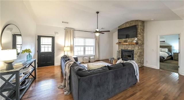 living room featuring a fireplace, dark wood-type flooring, ceiling fan, and vaulted ceiling