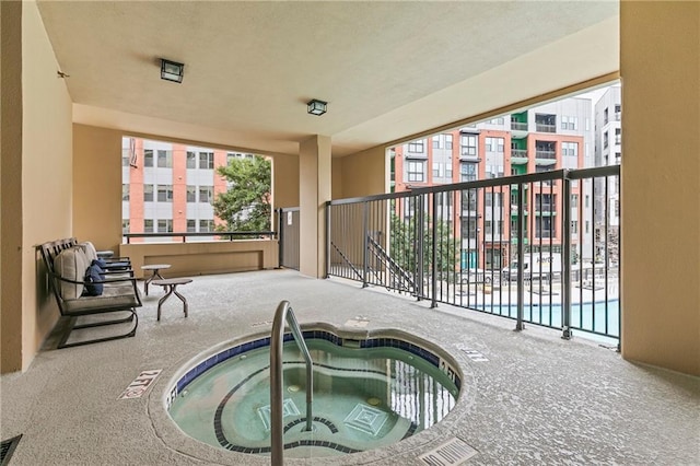 view of swimming pool featuring an indoor hot tub