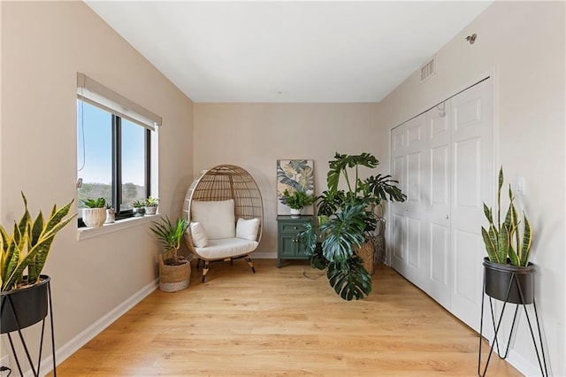 sitting room featuring light hardwood / wood-style floors