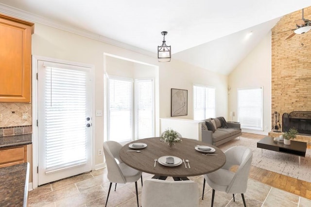 100 Bentwood Cir, Macon, GA 31210 - dining room with vaulted ceiling and a brick fireplace
