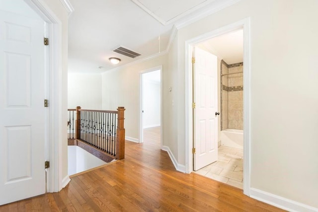 100 Bentwood Cir, Macon, GA 31210 - hallway with crown molding, an upstairs landing, attic access, wood finished floors, and baseboards