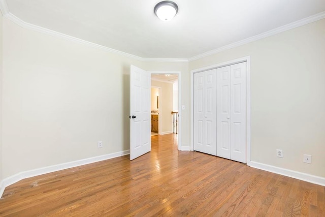 100 Bentwood Cir, Macon, GA 31210 - unfurnished bedroom featuring wood finished floors, ornamental molding, baseboards, and a closet