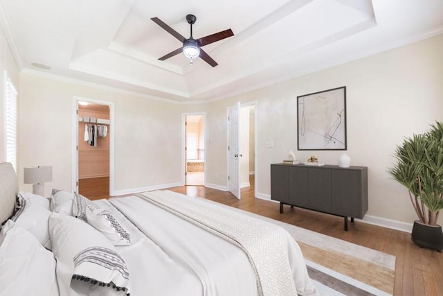 100 Bentwood Cir, Macon, GA 31210 - bedroom with a raised ceiling, wood finished floors, ensuite bath, ceiling fan, and baseboards