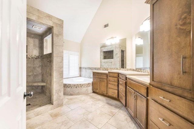 100 Bentwood Cir, Macon, GA 31210 - full bath with a tile shower, a bath, two vanities, marble look tiles, and high vaulted ceiling