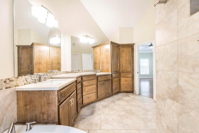100 Bentwood Cir, Macon, GA 31210 - full bathroom featuring a tub, ceiling fan, vanity, vaulted ceiling, and tile walls