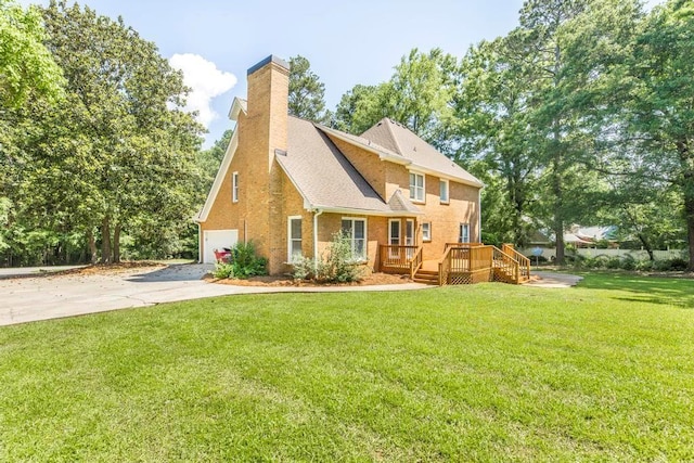 100 Bentwood Cir, Macon, GA 31210 - rear view of house with a wooden deck, concrete driveway, a lawn, a chimney, and a garage