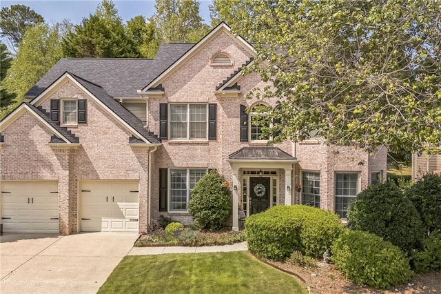 view of front of property with a front yard and a garage