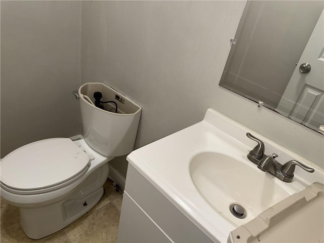 half bathroom featuring toilet and vanity