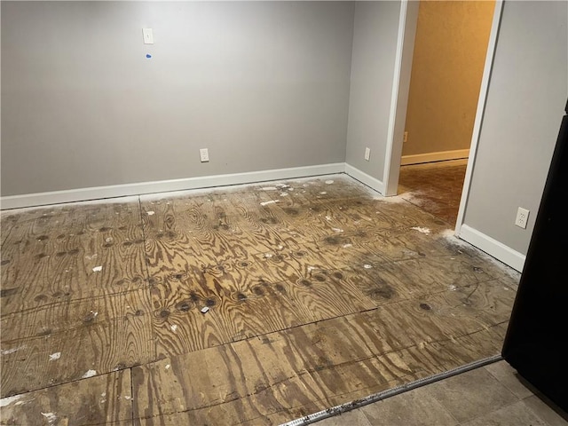 spare room featuring baseboards