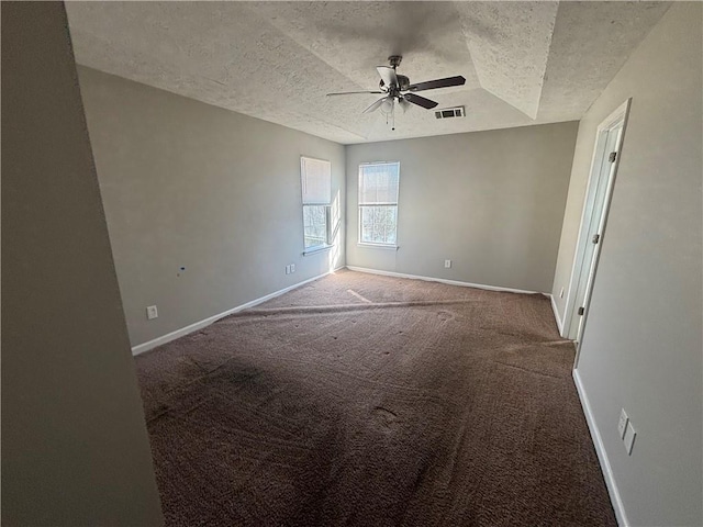 unfurnished room with visible vents, a ceiling fan, a textured ceiling, carpet, and baseboards