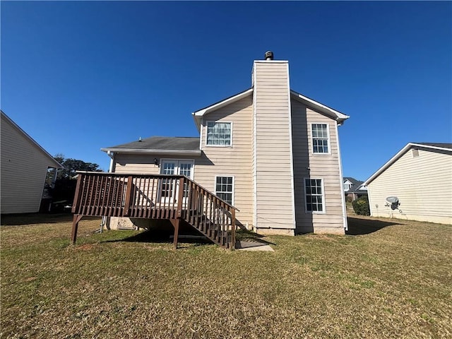 rear view of property featuring a deck, stairway, a chimney, and a yard