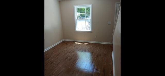 522 Jackson St, Rockmart, GA 30153 - spare room featuring dark wood-type flooring and baseboards