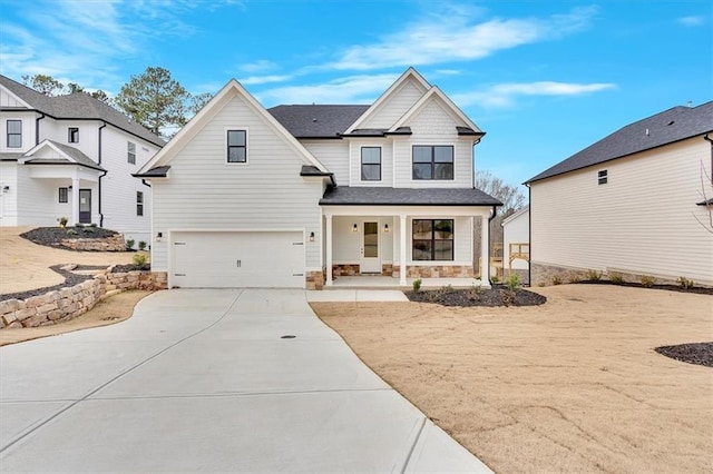 view of front of house featuring a porch and a garage