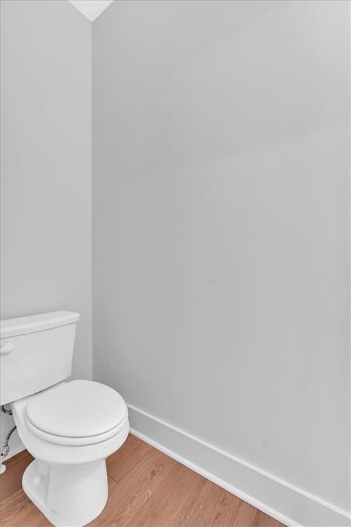 bathroom featuring hardwood / wood-style flooring and toilet