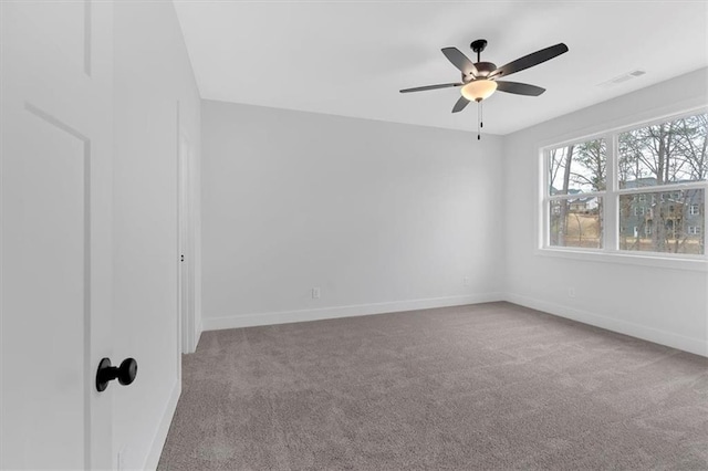 carpeted spare room with ceiling fan