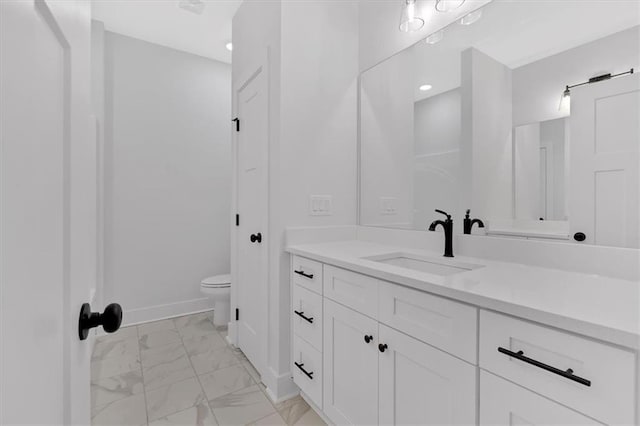 bathroom featuring vanity and toilet