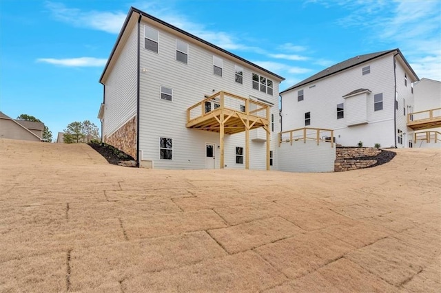 rear view of house featuring a deck